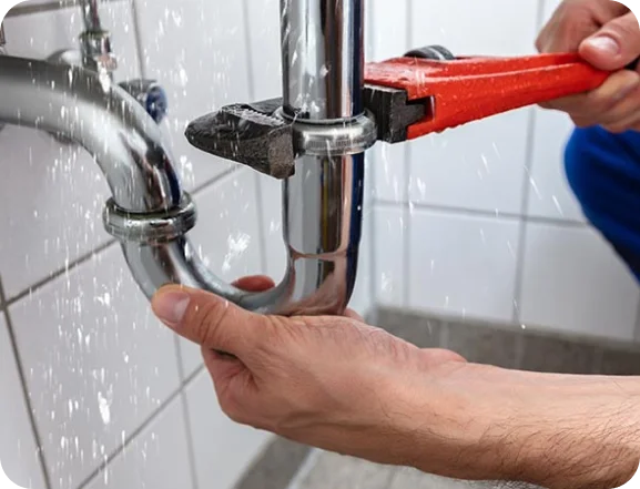 ipswich plumbers holding big red wrench fixing sink